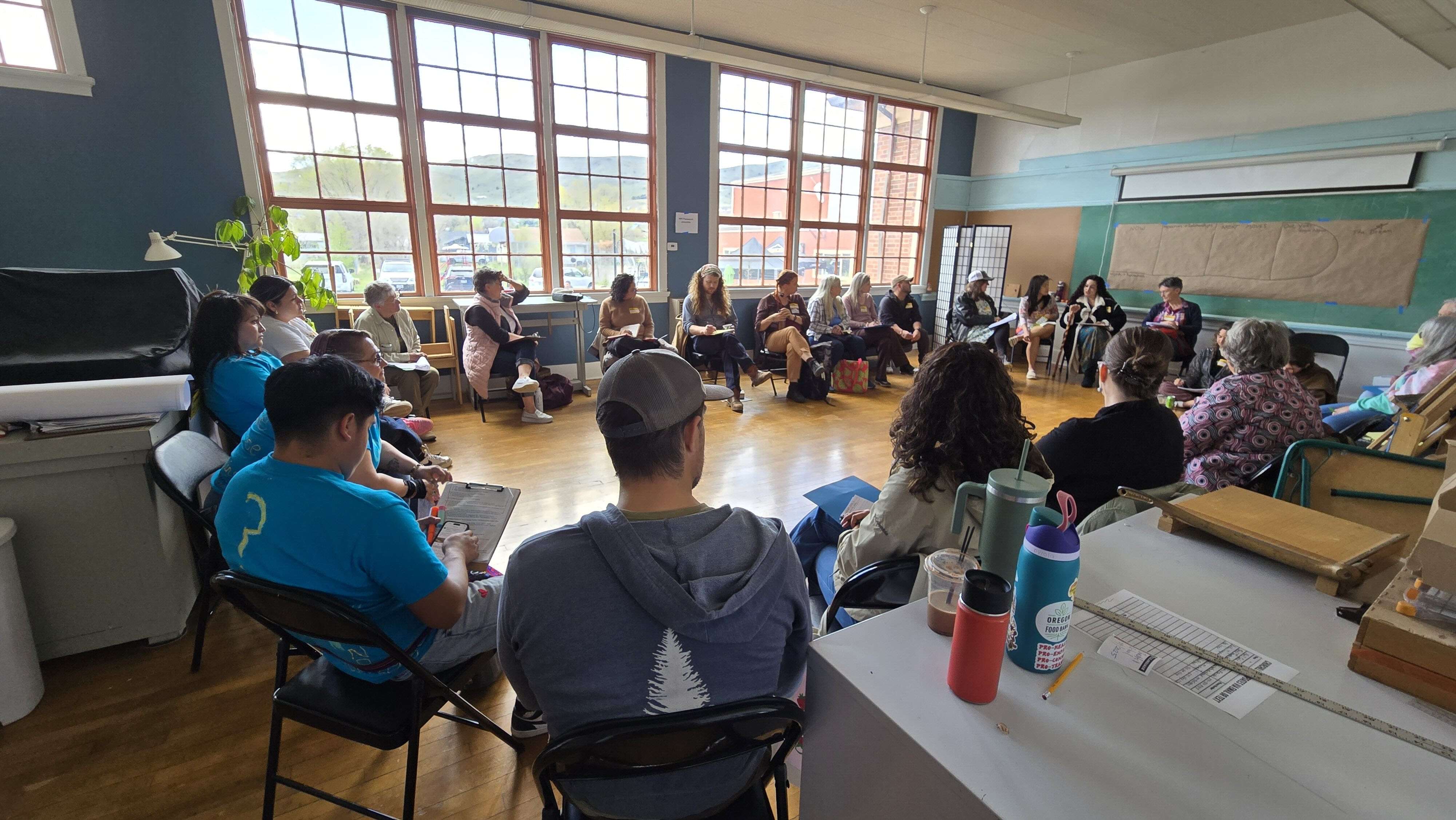 People sit in a circle of chairs during the immigrant justice session.